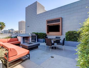a patio with couches and chairs and a fire pit